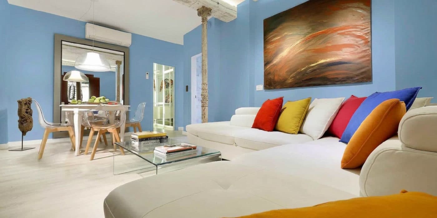 The bright living room virtually repainted Dusty Blue
