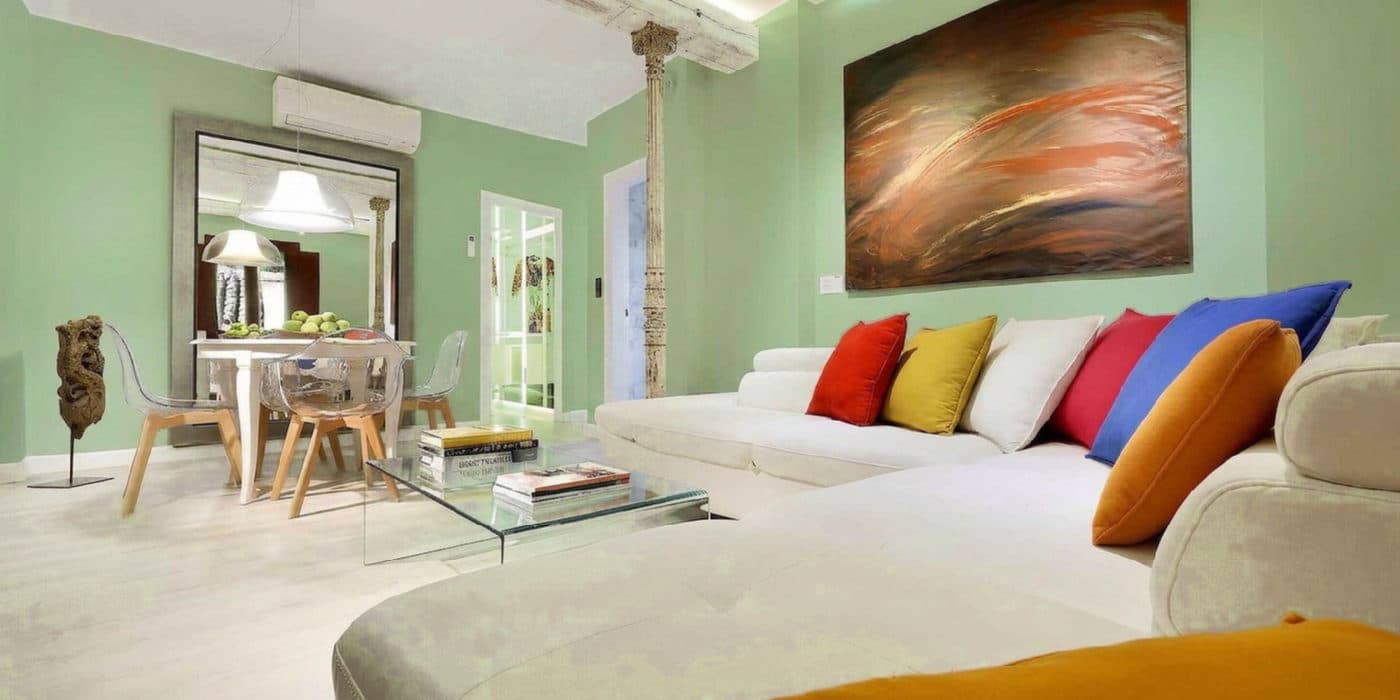 A bright living room virtually repainted sage green by TestMyPaint